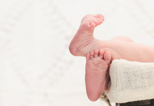Newborn baby feet on a soft blanket