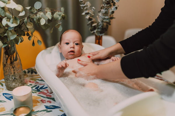 Mum bathing her baby
