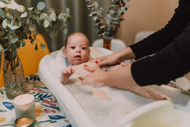 Mum bathing her baby