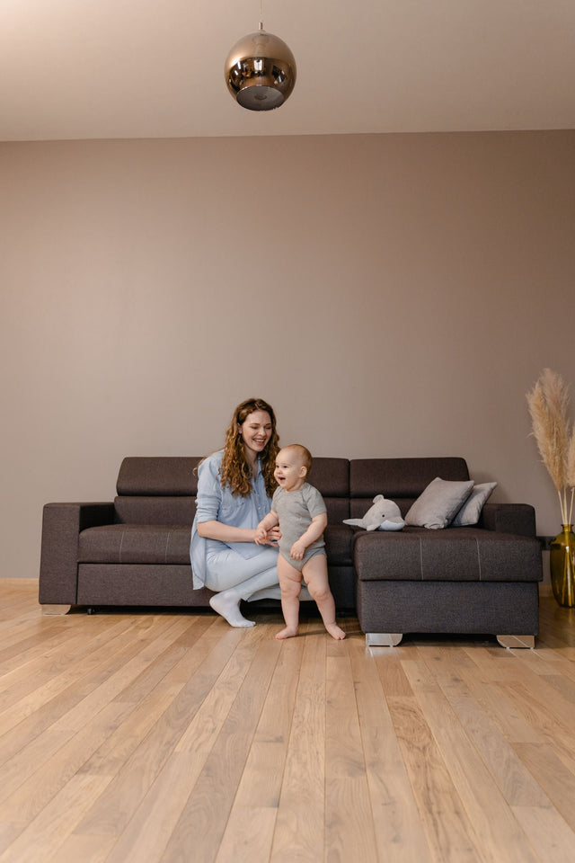 Mum playing with her toddler in the living room